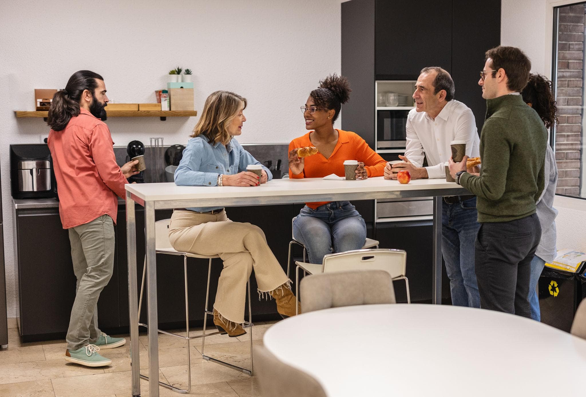 Employees enjoying refreshments in a modern workplace
